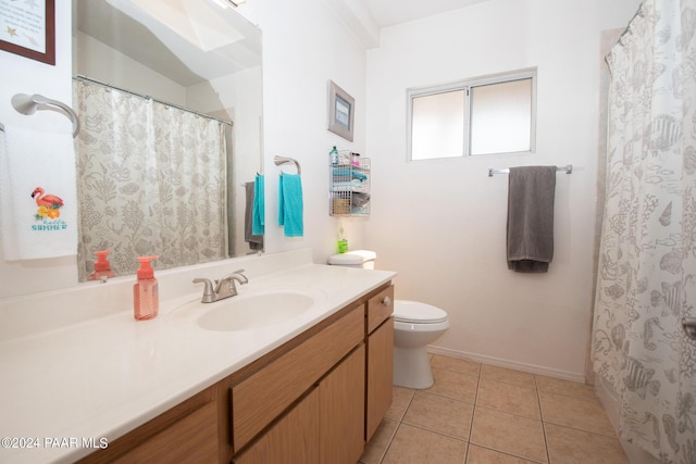 bathroom with tile patterned flooring, vanity, and toilet