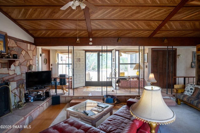 55409 Madre Cir, Seligman, AZ 86337 - living room featuring wood ceiling with exposed beams, a tiled fireplace, ceiling fan, and wood finished floors