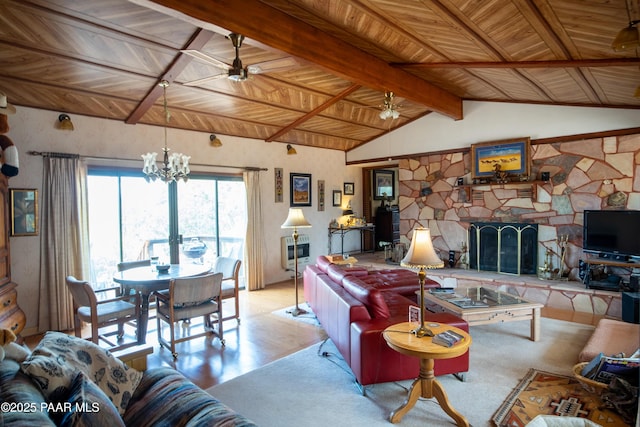 55409 Madre Cir, Seligman, AZ 86337 - living room featuring a chandelier, a stone fireplace, wood finished floors, wood ceiling, and ceiling fan