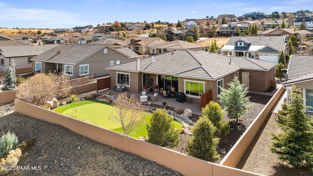 back of property with a patio