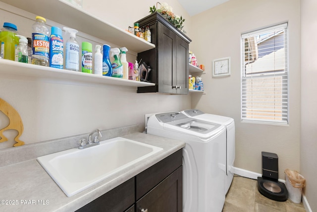 laundry area featuring sink, cabinets, and independent washer and dryer