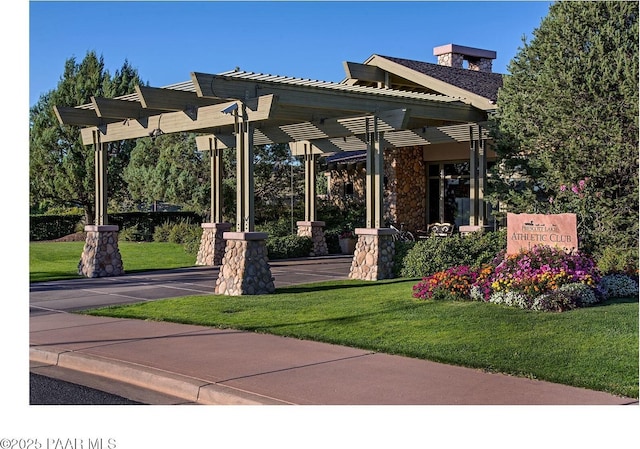 surrounding community featuring a lawn and a pergola