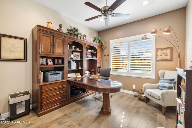 office area with ceiling fan and light hardwood / wood-style flooring