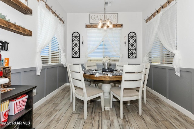 dining area featuring a chandelier and light hardwood / wood-style flooring