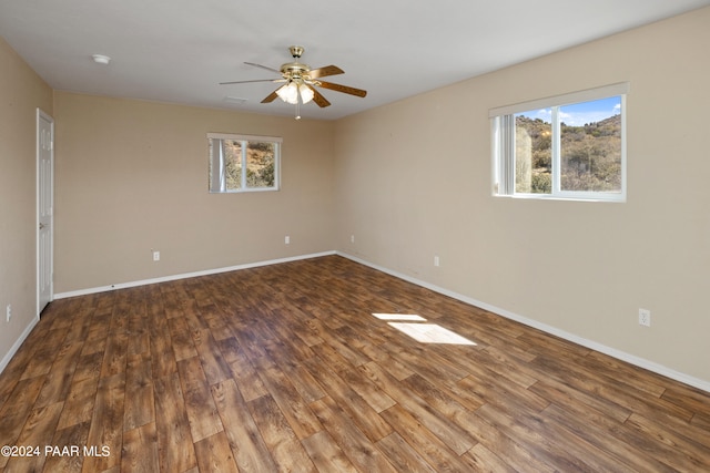 15015 E White Dr, Dewey-Humboldt, AZ 86327 - empty room with healthy amount of natural light, wood finished floors, a ceiling fan, and baseboards