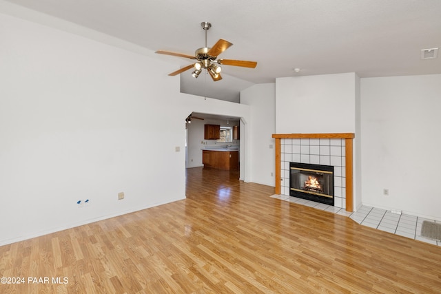 15015 E White Dr, Dewey-Humboldt, AZ 86327 - unfurnished living room with a ceiling fan, wood finished floors, a fireplace, lofted ceiling, and baseboards