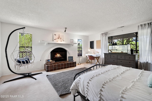 2008 Forest Hills Rd, Prescott, AZ 86303 - carpeted bedroom featuring multiple windows, a fireplace, and a textured ceiling