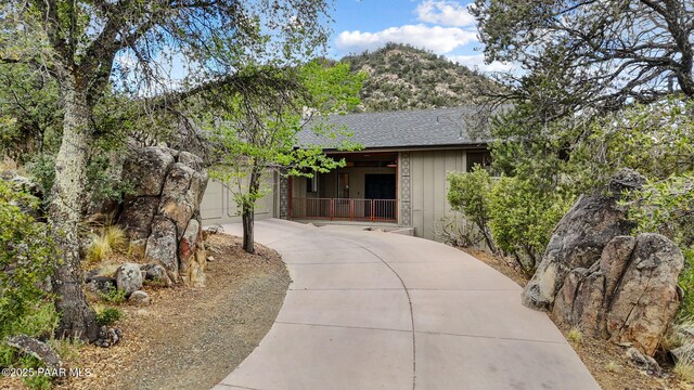 2008 Forest Hills Rd, Prescott, AZ 86303 - view of front of home with concrete driveway, a shingled roof, an attached garage, and a mountain view