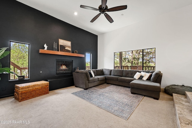2008 Forest Hills Rd, Prescott, AZ 86303 - carpeted living room with a lit fireplace, a ceiling fan, a high ceiling, and recessed lighting