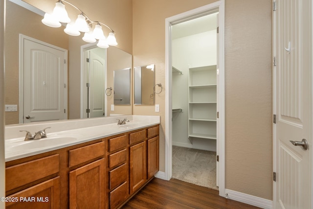 bathroom with hardwood / wood-style floors, a chandelier, and vanity