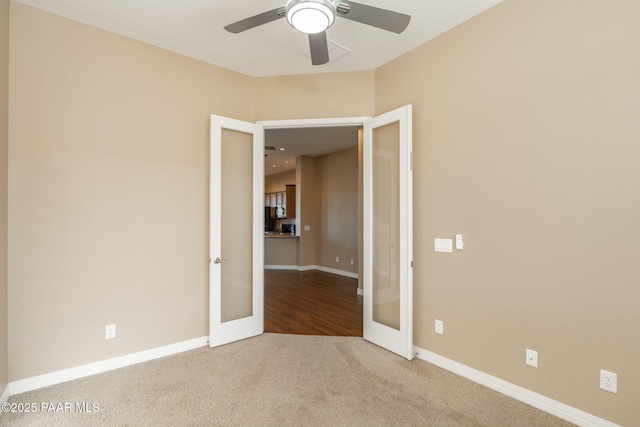 unfurnished room with ceiling fan, carpet, and french doors