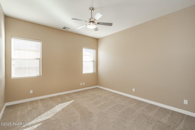 carpeted spare room featuring ceiling fan