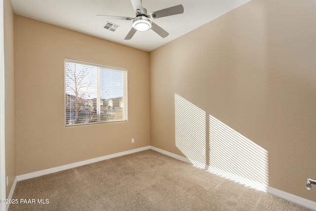 unfurnished room featuring ceiling fan and light colored carpet