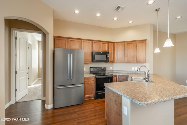 kitchen featuring kitchen peninsula, sink, decorative light fixtures, dark hardwood / wood-style floors, and black appliances