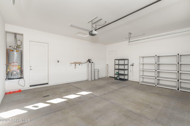 garage featuring gas water heater and a garage door opener