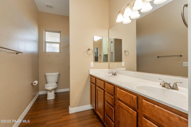 bathroom with wood-type flooring, toilet, and vanity