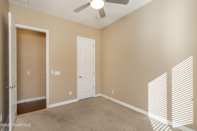 unfurnished bedroom featuring ceiling fan, light colored carpet, and a closet