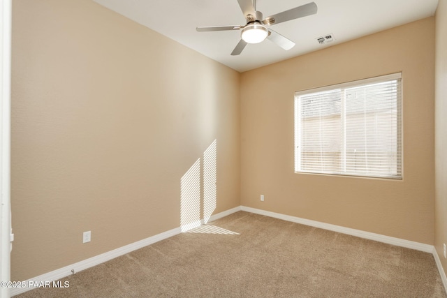 carpeted spare room featuring ceiling fan