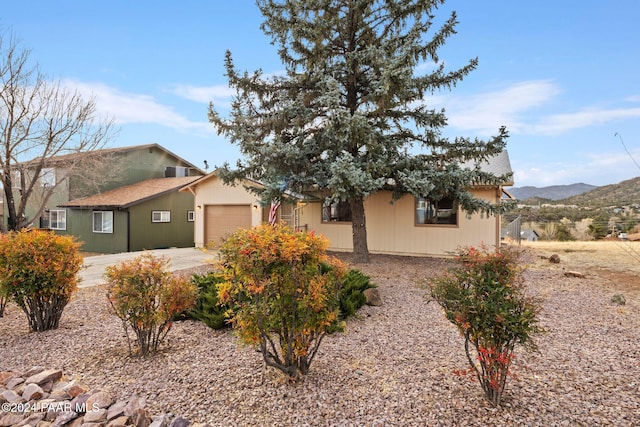 view of front of property featuring a mountain view and a garage