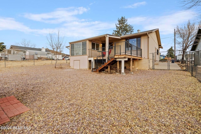 back of property featuring a wooden deck