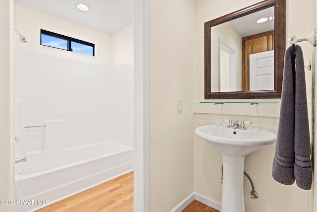 bathroom featuring shower / bathing tub combination and wood-type flooring