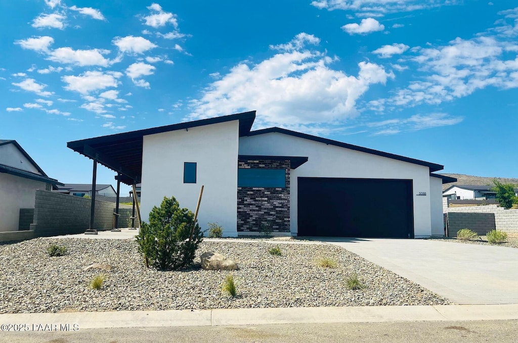 5088 N Jeffers Ave, Prescott Valley, AZ 86314 - view of front of home with stucco siding, concrete driveway, and an attached garage