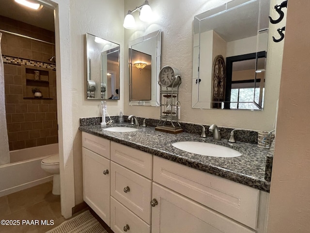 full bathroom featuring a textured wall, toilet, and a sink