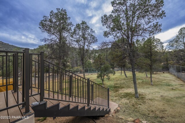view of yard featuring fence and stairs