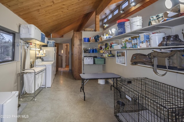 kitchen featuring lofted ceiling, finished concrete floors, freestanding refrigerator, and wooden ceiling