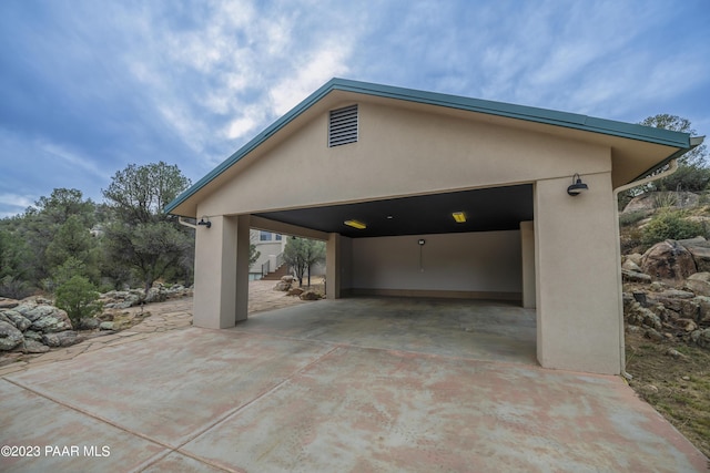 exterior space featuring stucco siding and driveway