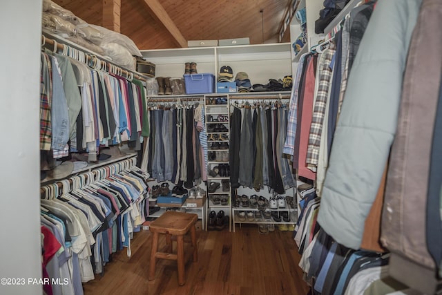 walk in closet featuring beam ceiling and wood finished floors