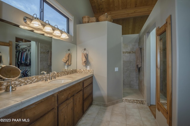 bathroom featuring wooden ceiling, vanity, tile patterned floors, a tile shower, and a spacious closet