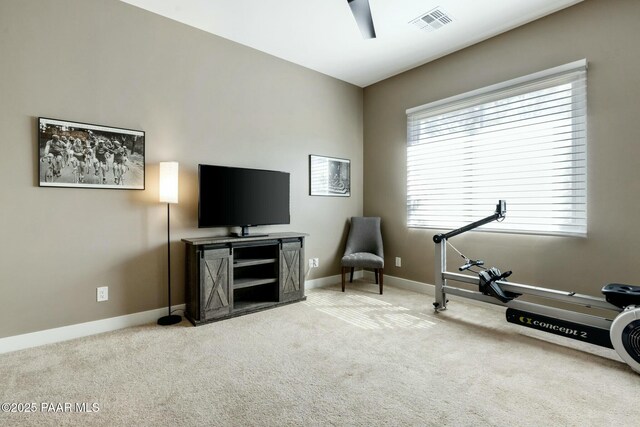 workout room with ceiling fan and carpet flooring