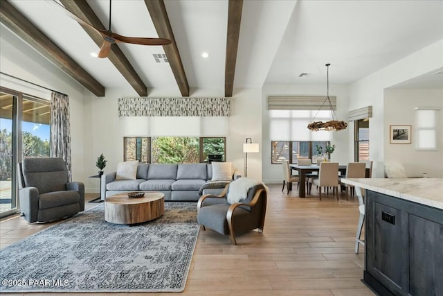 living room with beamed ceiling, ceiling fan, and light hardwood / wood-style flooring