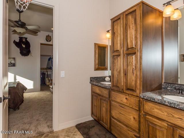 bathroom with ceiling fan and vanity