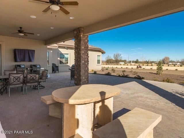 view of patio featuring area for grilling and ceiling fan