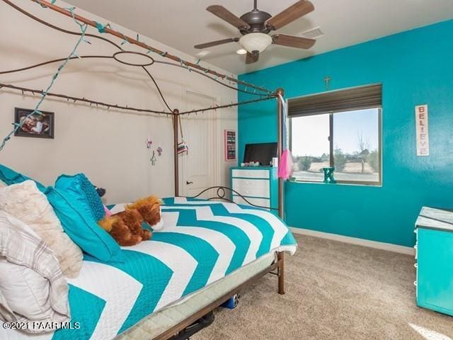 bedroom featuring ceiling fan and carpet floors