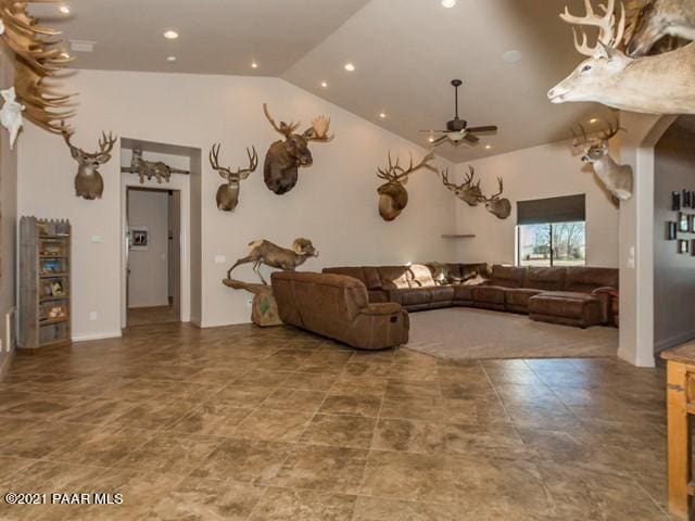 unfurnished living room with ceiling fan and lofted ceiling