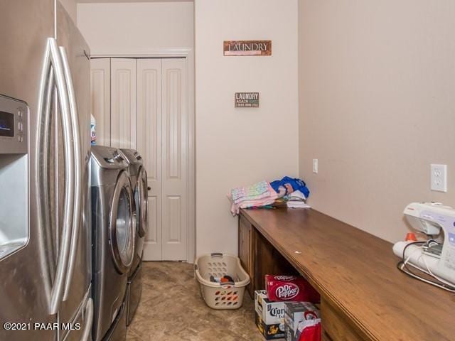 clothes washing area with washing machine and dryer