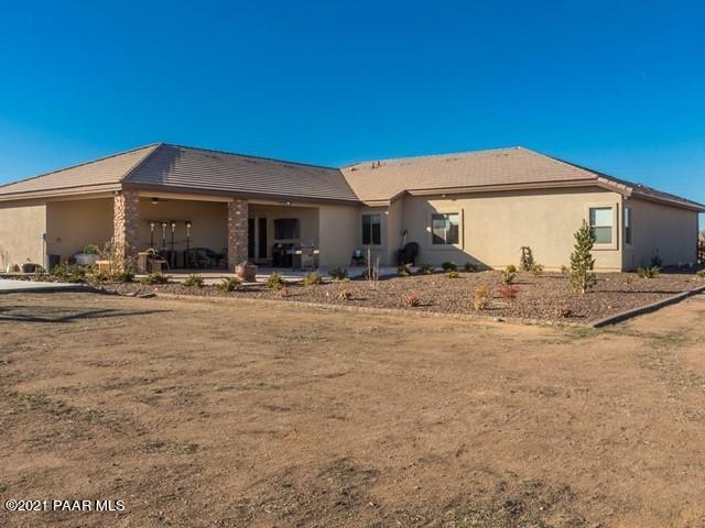 back of property with stucco siding and a patio area