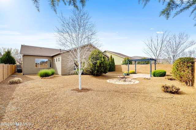 exterior space featuring stucco siding, a fenced backyard, a pergola, and a patio