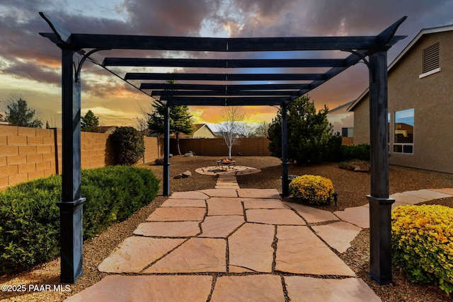 patio terrace at dusk with fence private yard and a pergola