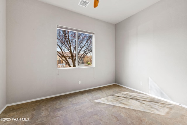 unfurnished room with a ceiling fan, visible vents, and baseboards