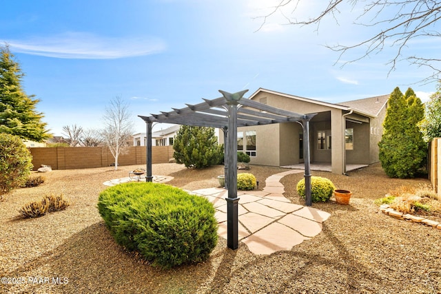 exterior space featuring a patio, a pergola, a fenced backyard, and stucco siding