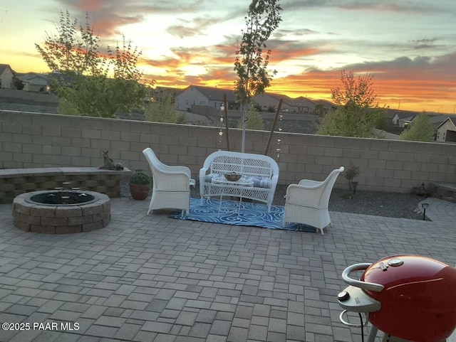 view of patio featuring a fire pit and fence