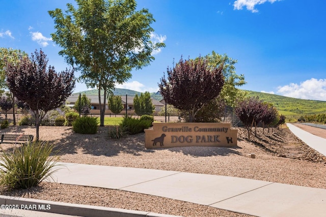 community sign with a mountain view