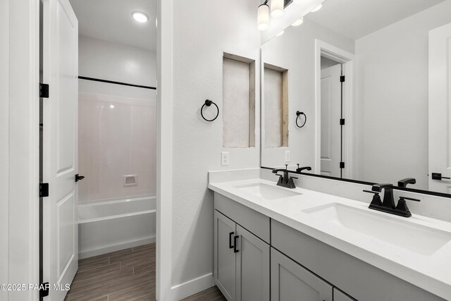 bathroom featuring shower / bathtub combination and vanity