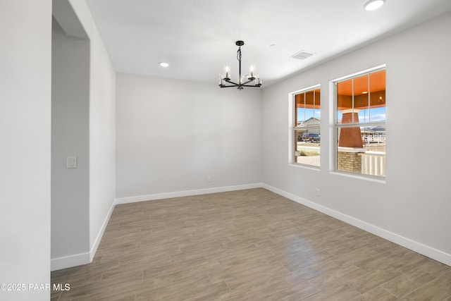 empty room featuring a chandelier