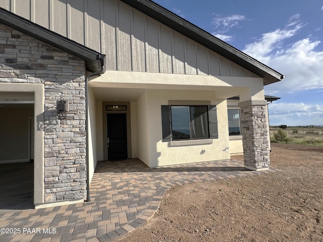 6670 E Rabbit Hole Way, Prescott Valley, AZ 86315 - property entrance featuring stone siding, board and batten siding, and stucco siding