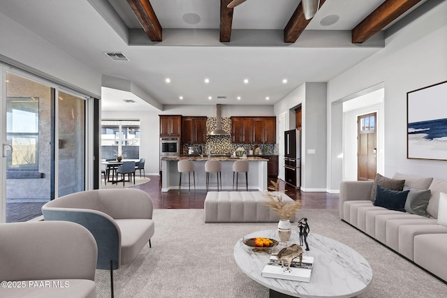 living area with dark wood-style flooring, recessed lighting, visible vents, beamed ceiling, and baseboards